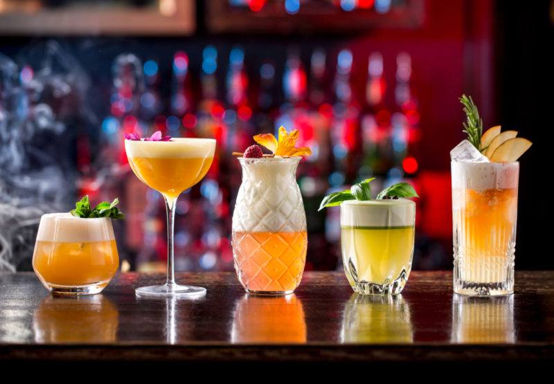 Variou cocktail fizzes on a bar