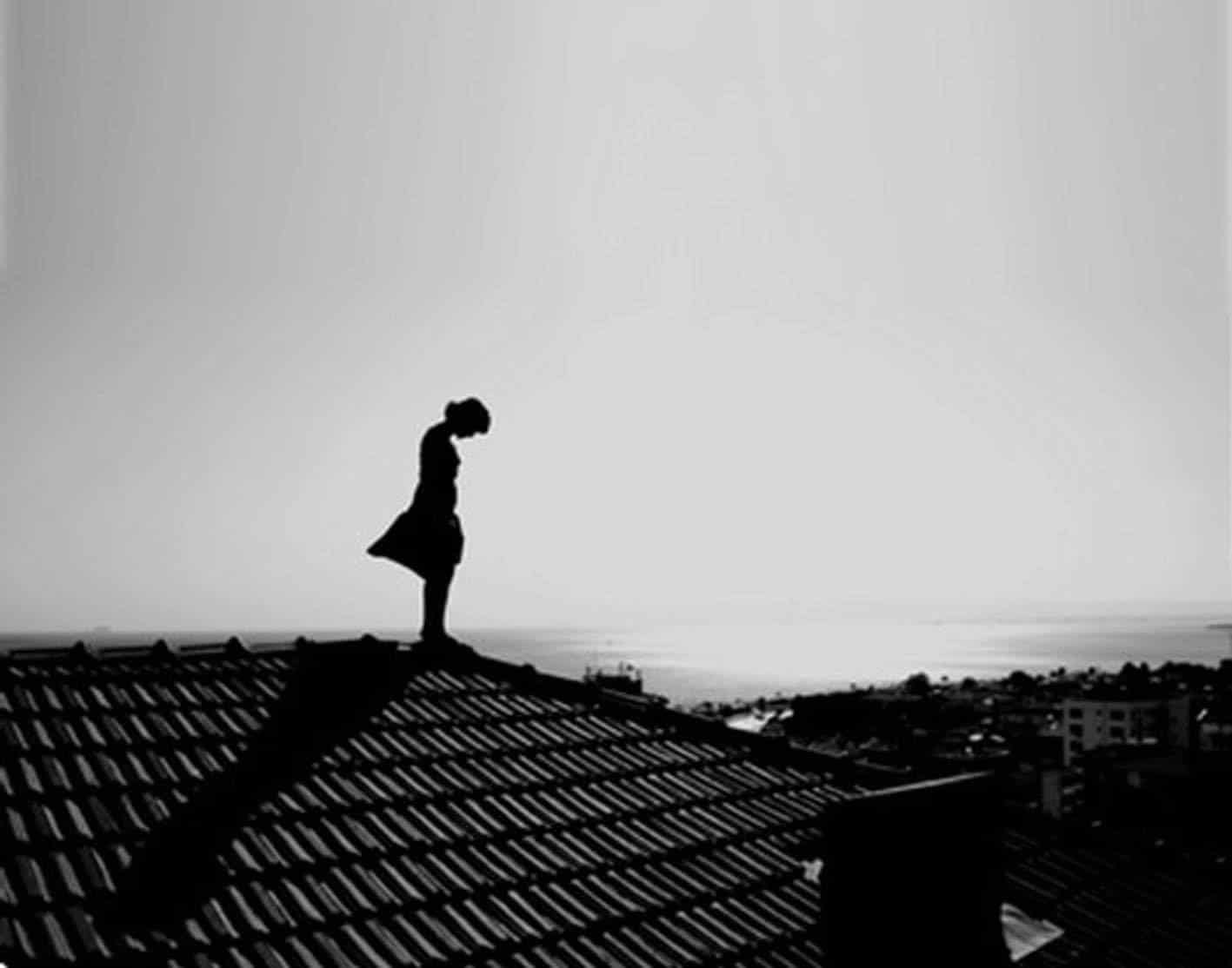 Hình cô gái buồn đứng trên mái nhà